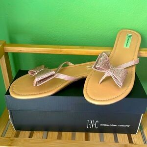Thong sandal with a rhinestone bow.